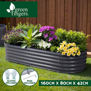 Raised garden bed with flowers and plants in backyard