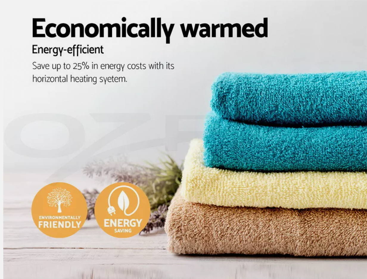 Soft towels stacked beside heated towel rail for drying