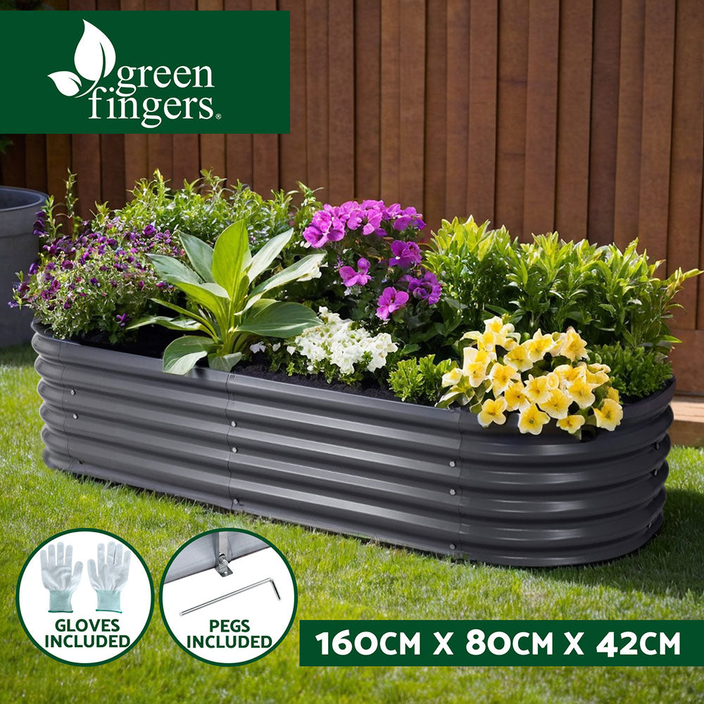 Raised garden bed with flowers and plants in backyard