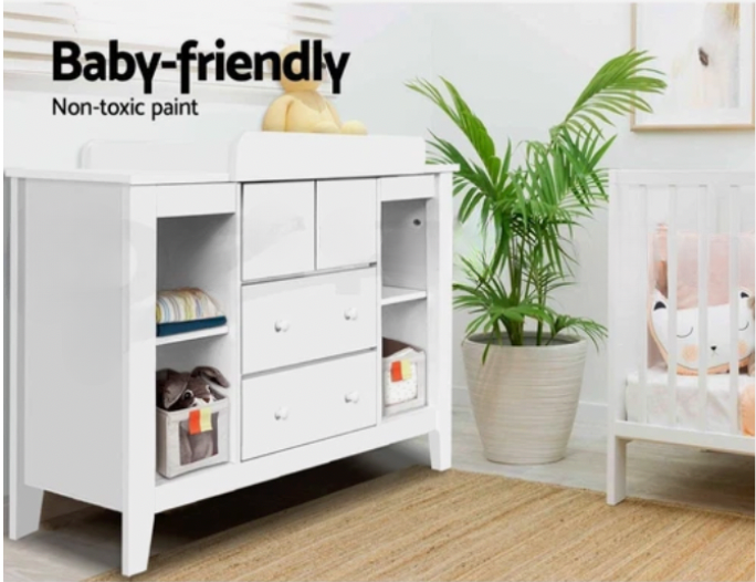 Modern baby change table in nursery with plants and decor